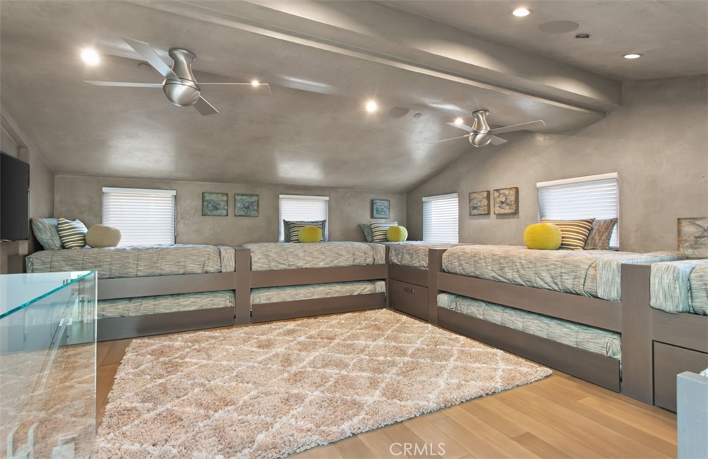 35461 Beach Road Dana Point, CA 92624 - Photo 32 of 46 a bedroom with a large bed and wooden floor