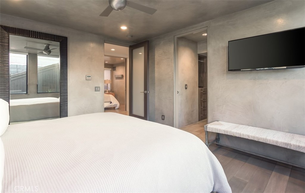 35461 Beach Road Dana Point, CA 92624 - Photo 34 of 46 a bedroom with a bed and a flat tv screen on wall