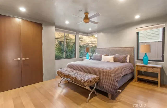 a bathroom with a granite countertop sink a toilet a mirror and shower