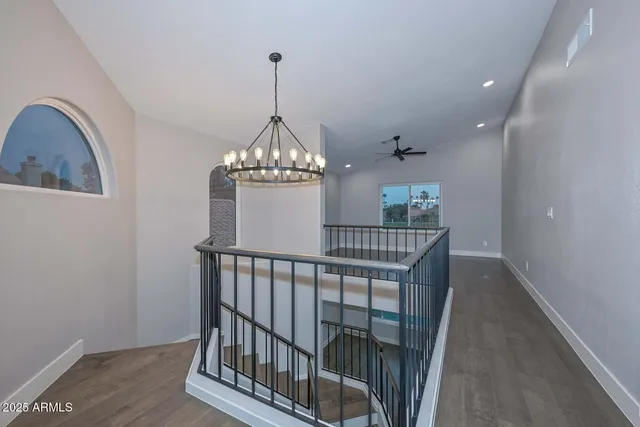 an empty room with ceiling fan and window