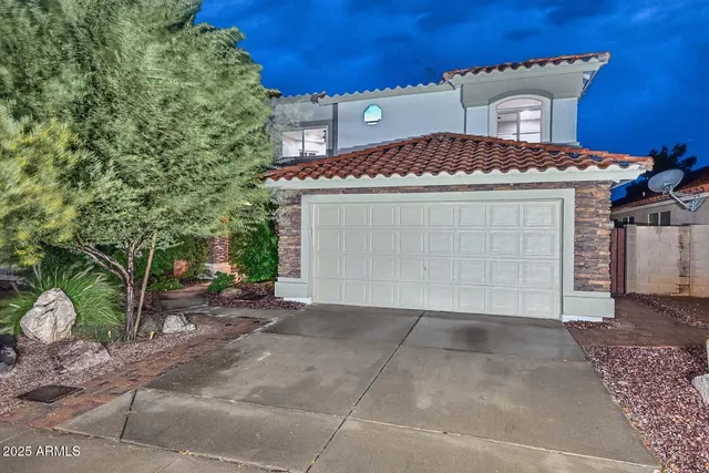 a view of a house with a yard and garage