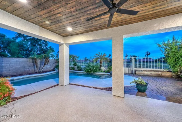 a view of a house with backyard porch and sitting area