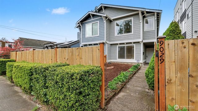 a view of a house with a small yard and plants