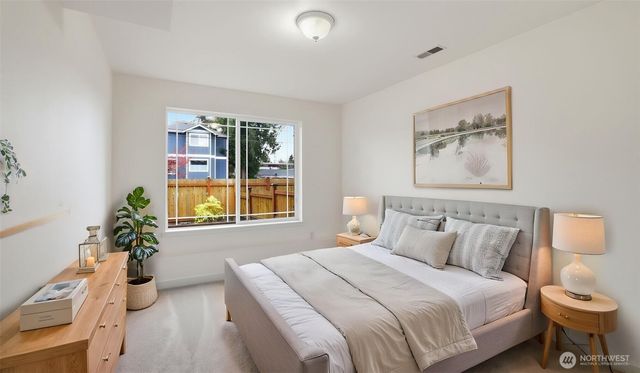 a bedroom with a bed and a potted plant