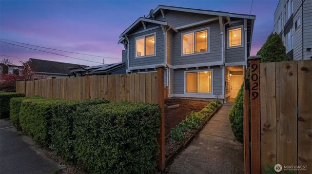 a view of a house with a wooden fence