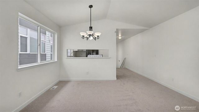 a view of a room with a chandelier furniture and windows