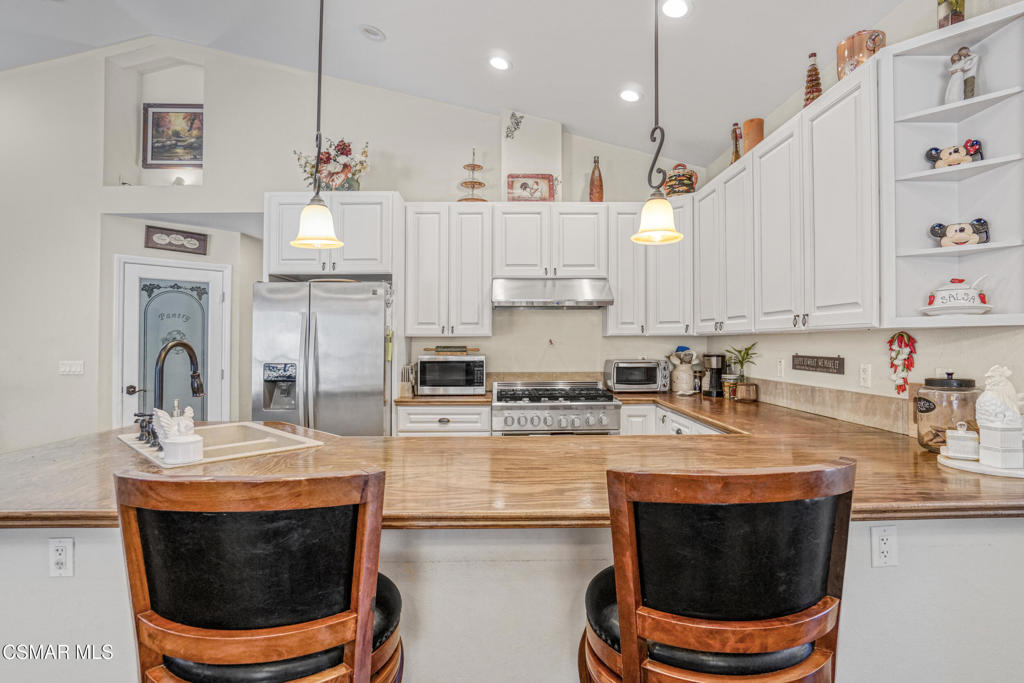 7368 Santa Susana Pass Road Simi Valley, CA 93063 - Photo 11 of 48 a kitchen with stainless steel appliances granite countertop a sink a stove a microwave a refrigerator and cabinets