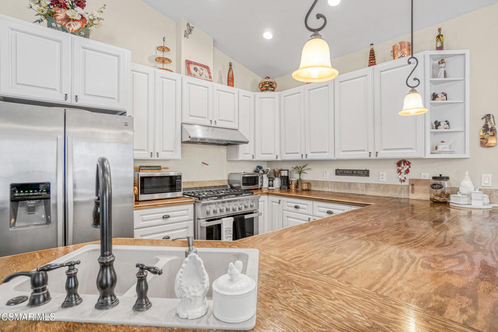 7368 Santa Susana Pass Road Simi Valley, CA 93063 - Photo 12 of 48 a kitchen with stainless steel appliances granite countertop a sink a stove and refrigerator