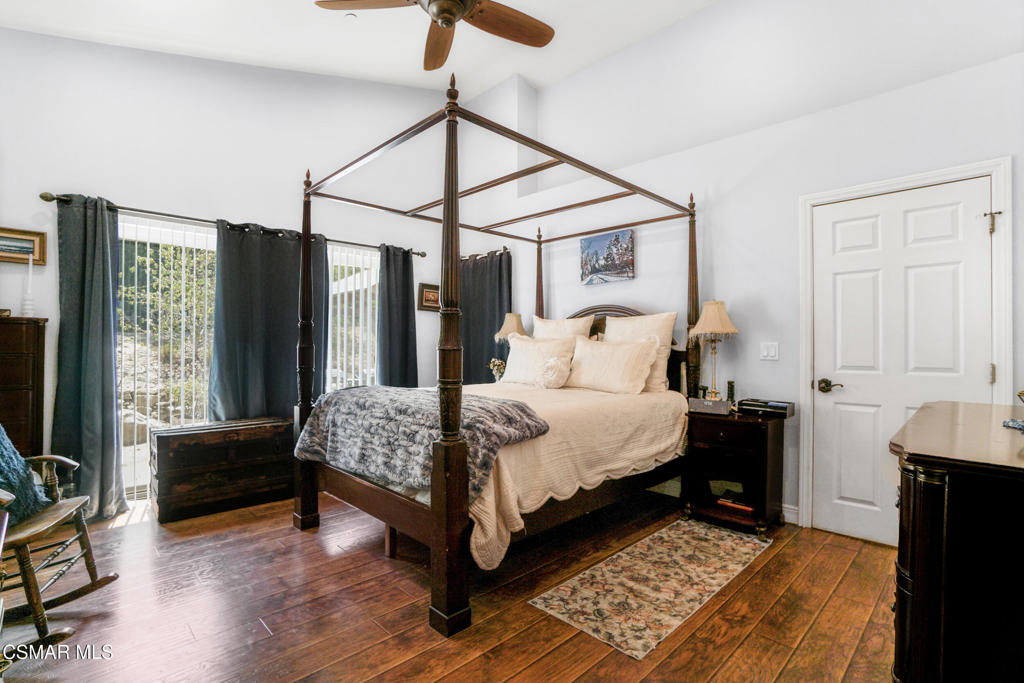 7368 Santa Susana Pass Road Simi Valley, CA 93063 - Photo 20 of 48 a bedroom with a bed next to a window with the flat screen tv
