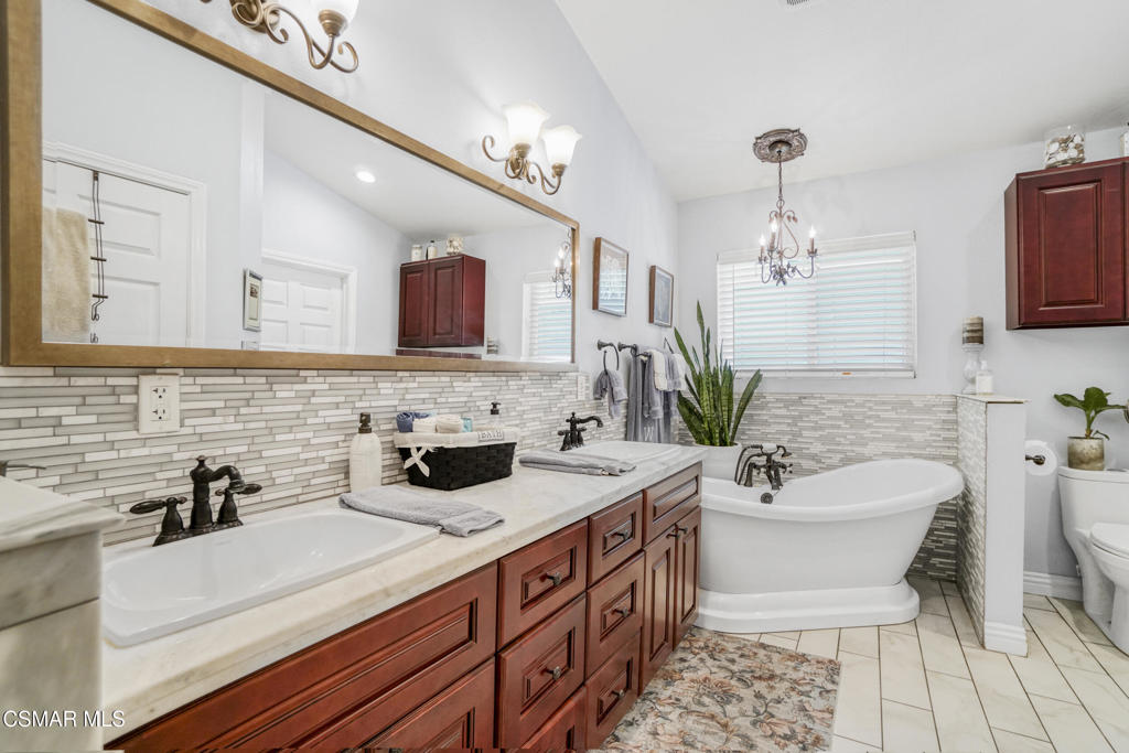 7368 Santa Susana Pass Road Simi Valley, CA 93063 - Photo 22 of 48 a bathroom with a sink a toilet and mirror