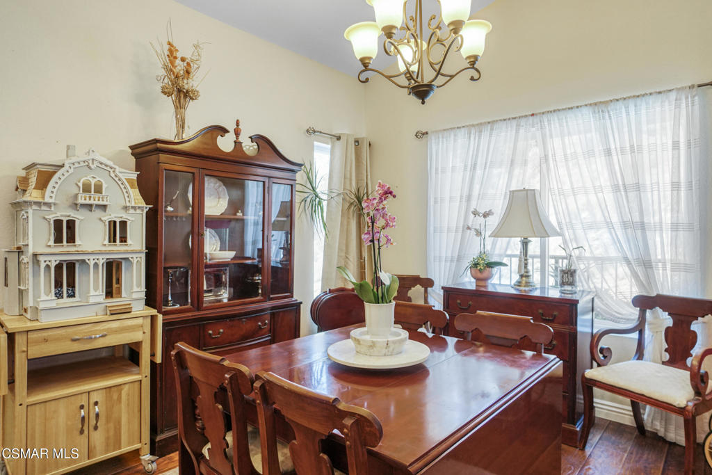 7368 Santa Susana Pass Road Simi Valley, CA 93063 - Photo 10 of 48 a view of a dining room with furniture a chandelier and large windows