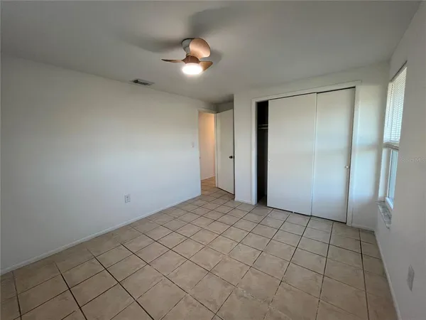 an empty room with kitchen view