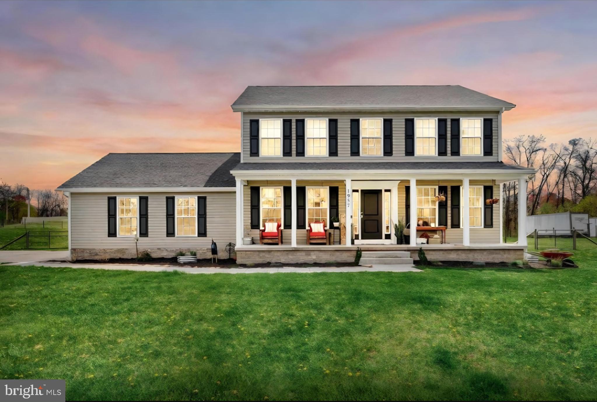 a front view of a house with a yard and patio