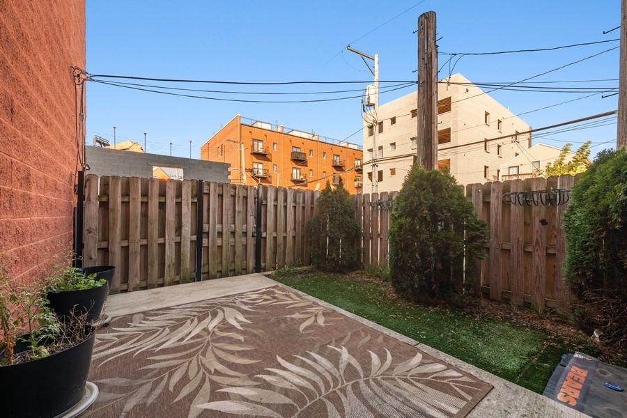2340 West Adams Street, Unit 33 Chicago, IL 60612 - Photo 2 of 17 a view of a pathway of a house with a wooden fence