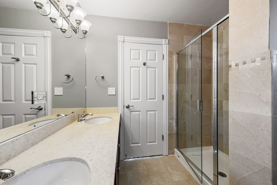 2340 West Adams Street, Unit 33 Chicago, IL 60612 - Photo 12 of 17 a bathroom with a tub sink and mirror