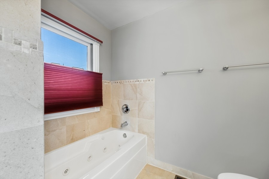 2340 West Adams Street, Unit 33 Chicago, IL 60612 - Photo 13 of 17 a bathroom with a bathtub and a shower