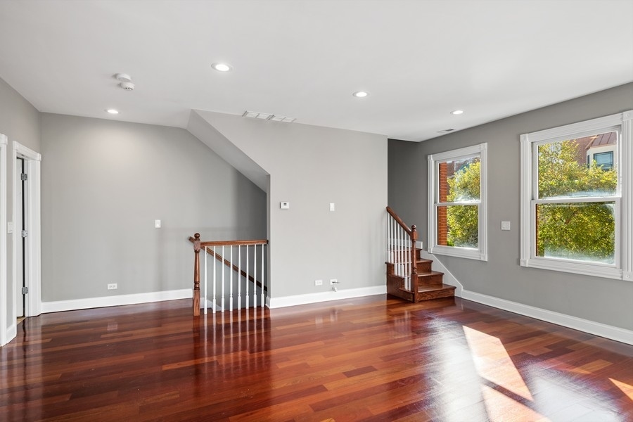 2340 West Adams Street, Unit 33 Chicago, IL 60612 - Photo 3 of 17 a view of a room with wooden floor staircase and windows