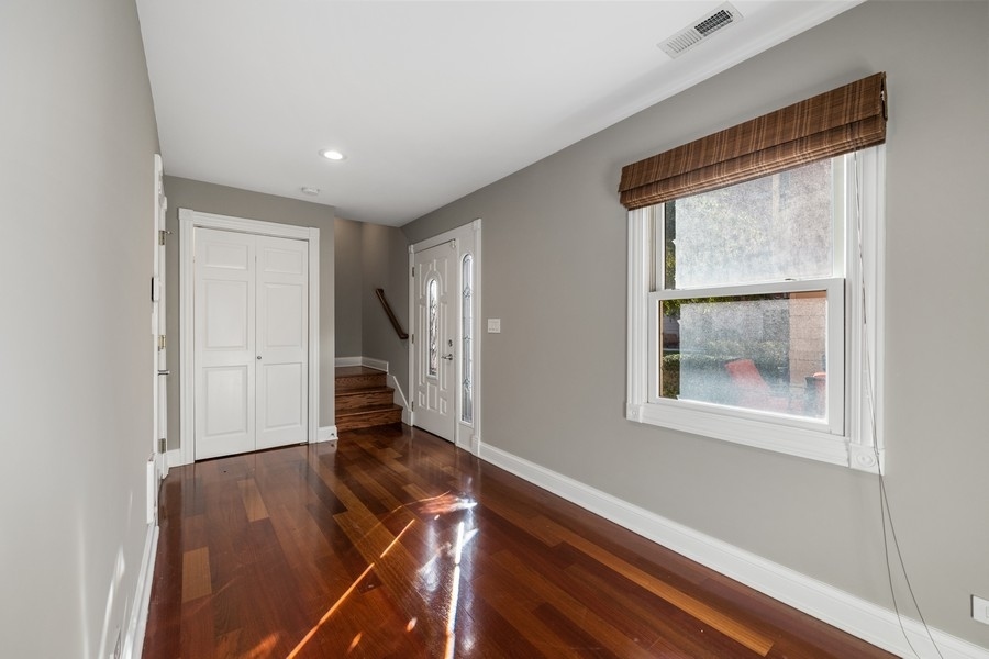 2340 West Adams Street, Unit 33 Chicago, IL 60612 - Photo 7 of 17 a view of an empty room with wooden floor and a window