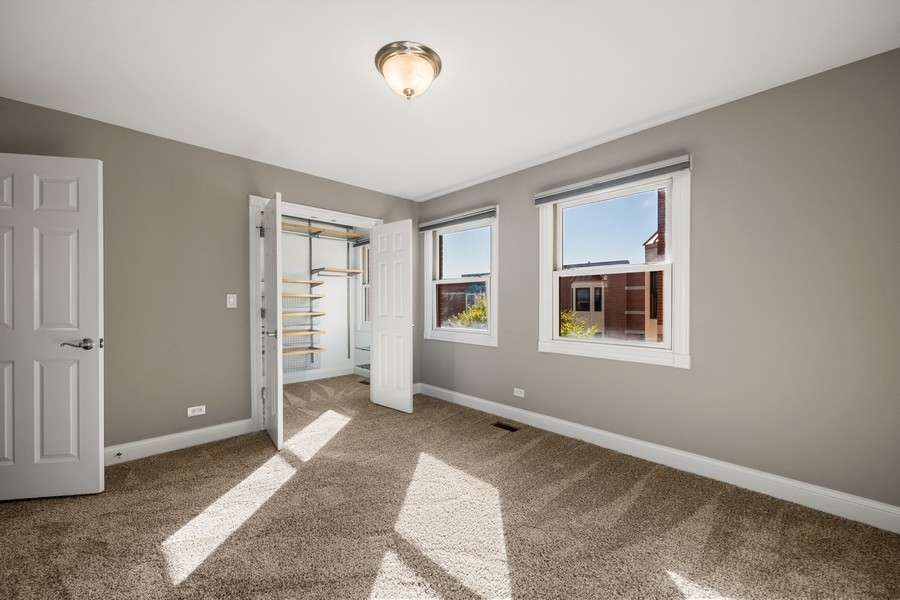 2340 West Adams Street, Unit 33 Chicago, IL 60612 - Photo 10 of 17 an empty room with windows
