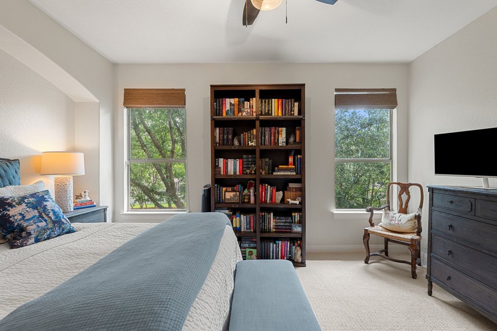 6708 Menchaca Road, Unit 2 Austin, TX 78745 - Photo 20 of 30 Carpeted room featuring multiple windows with natural wood-toned roller shades