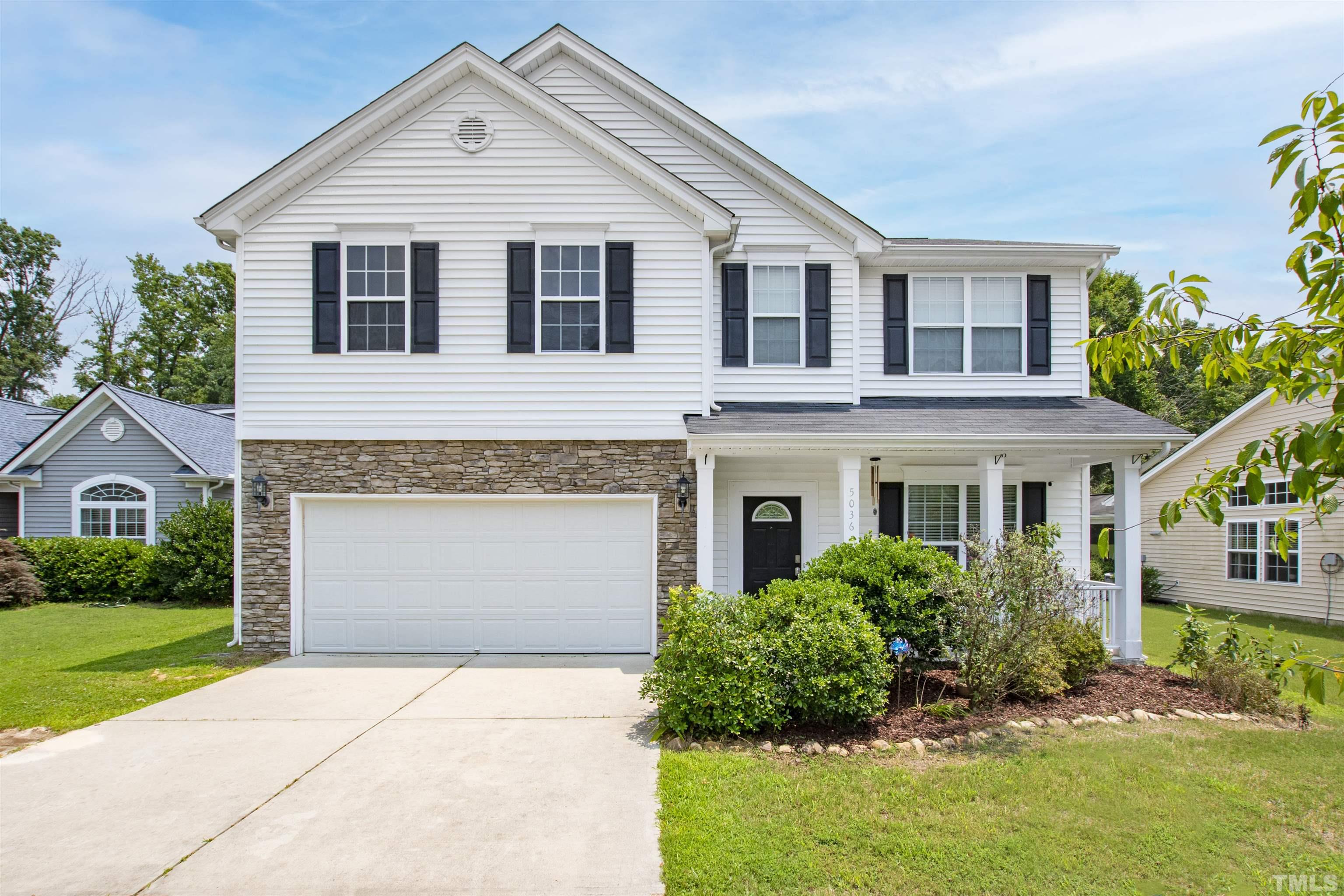 5036 McKittrick Lane Durham, NC 27712 - Photo 1 of 48 a front view of a house with a yard and garage