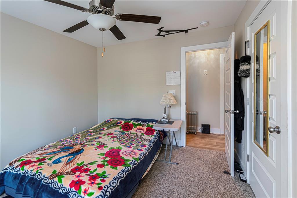 3336 Donna Way Gainesville, GA 30504 - Photo 16 of 30 a bedroom with a bed and a chandelier