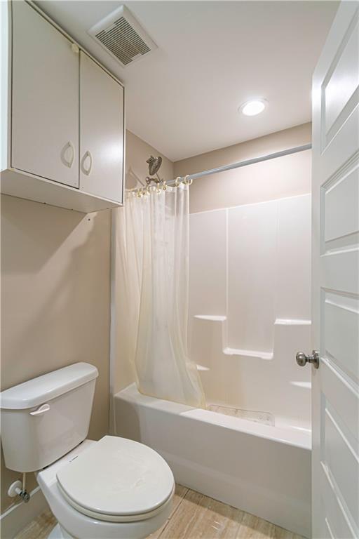 3336 Donna Way Gainesville, GA 30504 - Photo 18 of 30 a white toilet and tub sitting next to a bathroom sink
