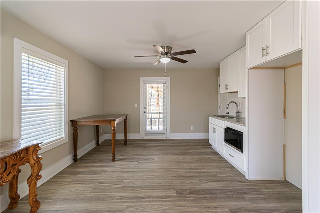 3336 Donna Way Gainesville, GA 30504 - Photo 21 of 30 a view of a livingroom with a fireplace a ceiling fan and wooden floor