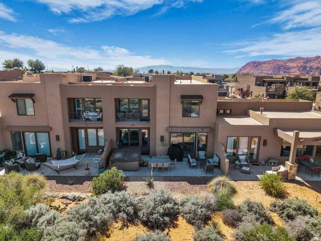 5010 Escapes Drive St. George, UT 84770 - Photo 29 of 46 Back of property featuring outdoor furniture, stucco siding, a patio area, and a mountain view