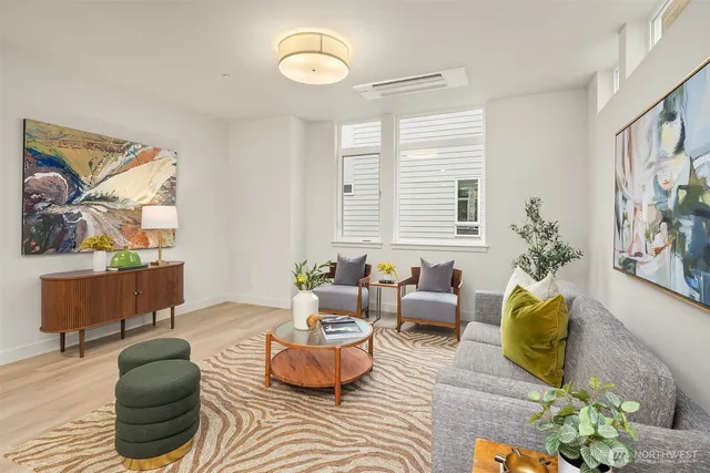a living room with furniture and a potted plant