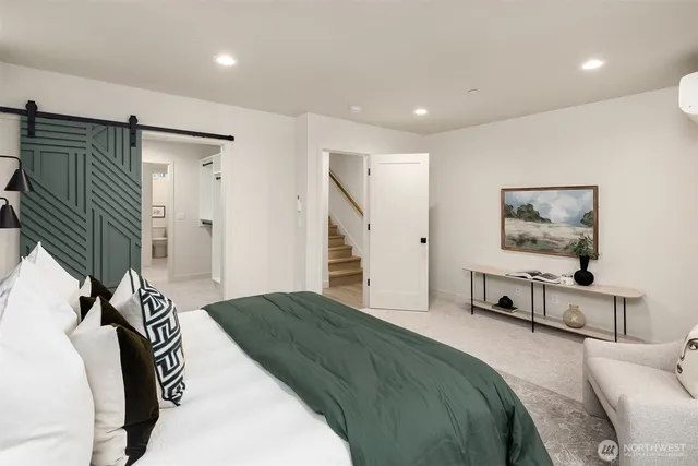 a bedroom with a bed and a large mirror