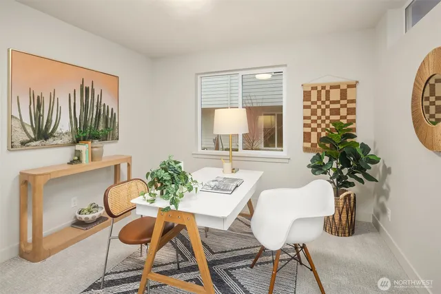 a dining room with furniture potted plants and wooden floor
