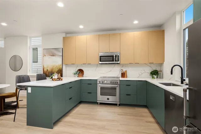 a kitchen with a sink cabinets and appliances