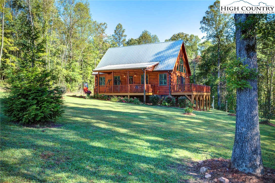 3460 South Center Church Road Thurmond, NC 28683 - Photo 7 of 50 a front view of house with a garden and trees