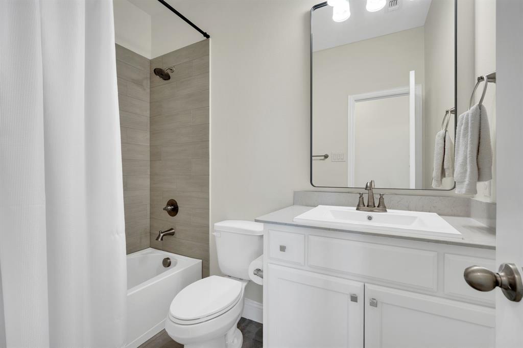 1601 Bear Path Way Gunter, TX 75058 - Photo 28 of 40 a bathroom with a toilet a sink a mirror a bathtub and vanity