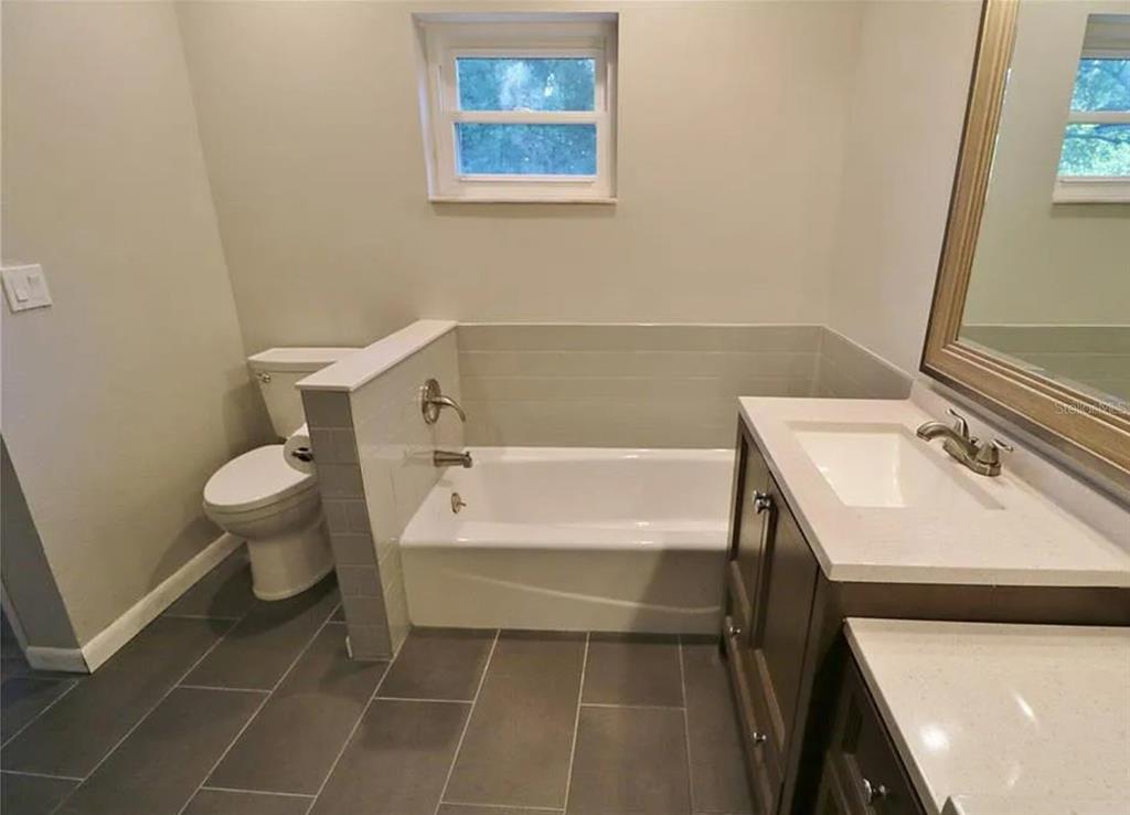 4472 Fairview Avenue Orlando, FL 32804 - Photo 11 of 18 a bathroom with a sink a toilet and a bathtub