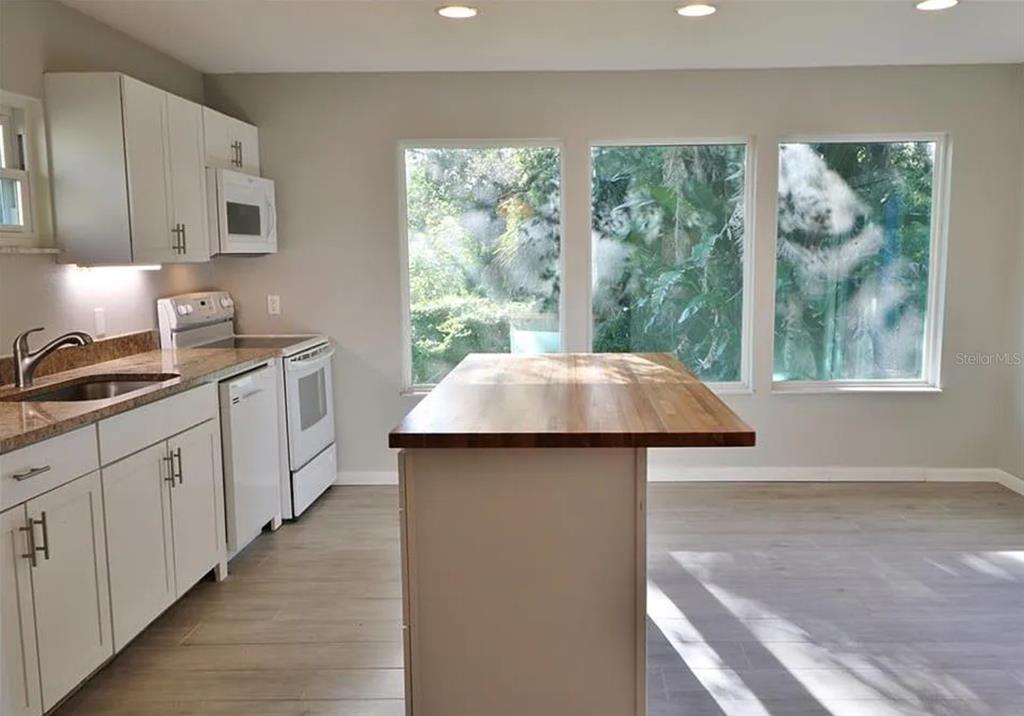4472 Fairview Avenue Orlando, FL 32804 - Photo 8 of 18 a kitchen with a sink and large window