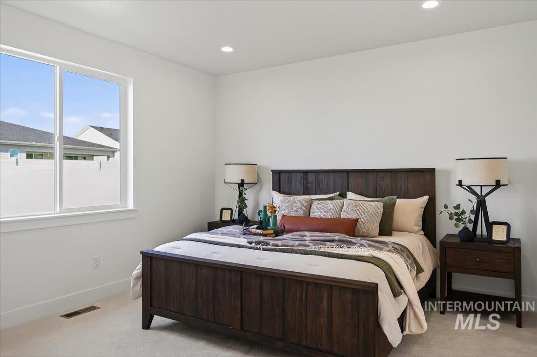 14880 Wing Spread Drive Caldwell, ID 83607 - Photo 6 of 12 Bedroom featuring a large double window, recessed lighting, and light-colored carpeting