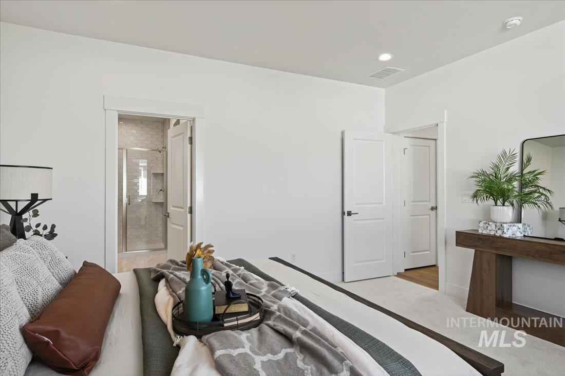 14880 Wing Spread Drive Caldwell, ID 83607 - Photo 7 of 12 Carpeted room featuring an en-suite bathroom with a glass-enclosed shower, recessed lighting, white walls, and white trim