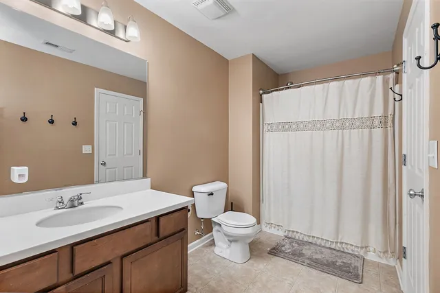 a bathroom with a toilet a sink and a mirror