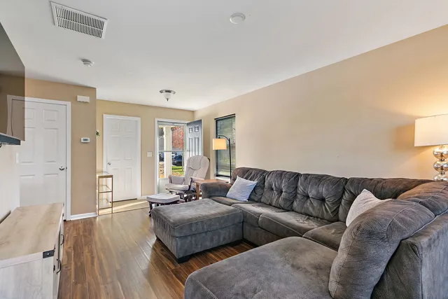a living room with furniture and wooden floor
