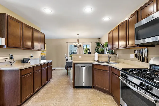 a kitchen with lots of counter top space sink and stainless steel appliances