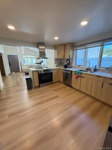 a large kitchen with stainless steel appliances kitchen island granite countertop a large counter top cabinets and stainless steel appliances