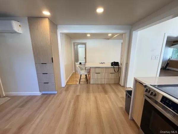 a view of a kitchen with wooden floor and electronic appliances