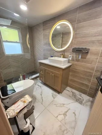 a bathroom with a sink mirror and toilet