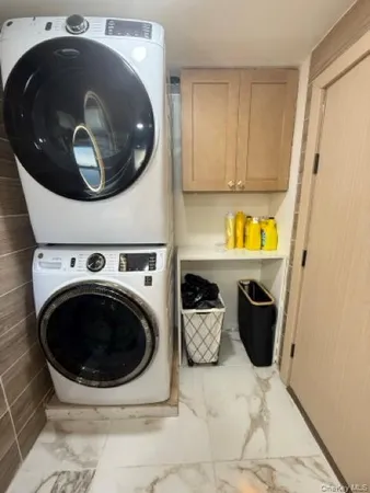 a close view of a utility room with washer and dryer