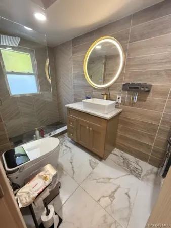 a bathroom with a sink mirror and toilet