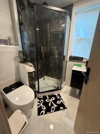 a bathroom with a toilet and a shower
