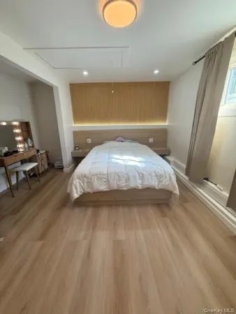 a spacious bedroom with a bed and a chandelier