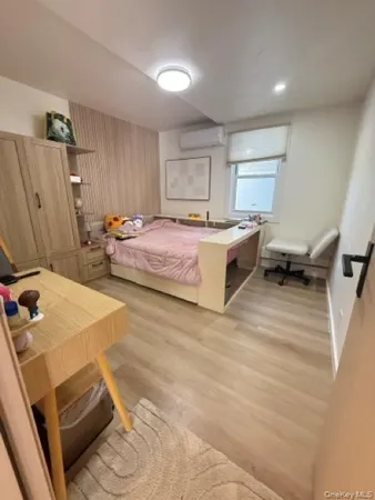 a spacious bedroom with a bed and a flat screen tv